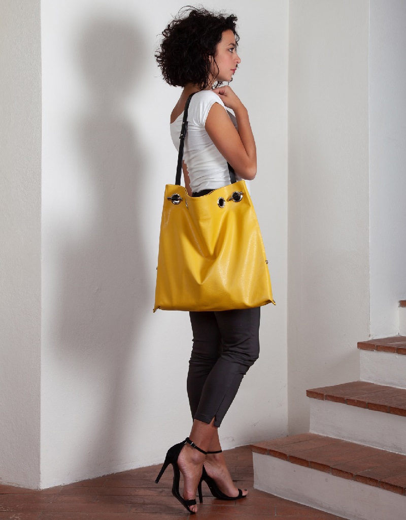 DORIANA & SHOULDER STRAP in yellow granulated leather, worn by model DORIANA & SHOULDER STRAP in yellow granulated leather, worn by model